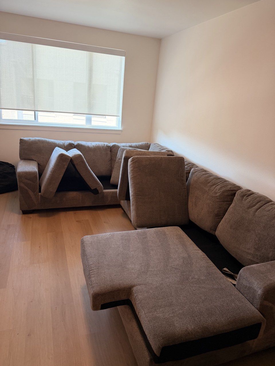 Brown sectional with cushions propped up to dry after cleaning
