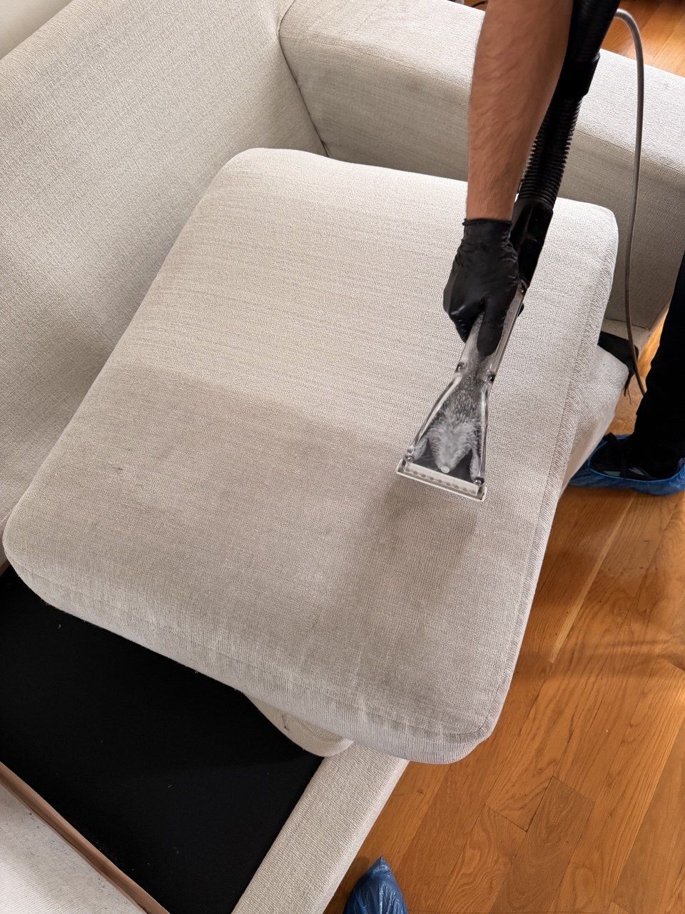 Hot water extraction wand on a cream seat cushion