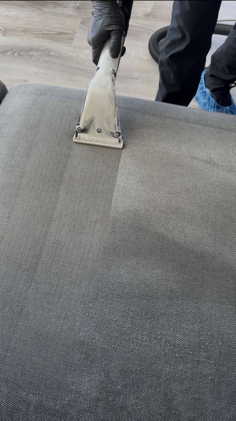 Half-cleaned sectional cushion showing before and after